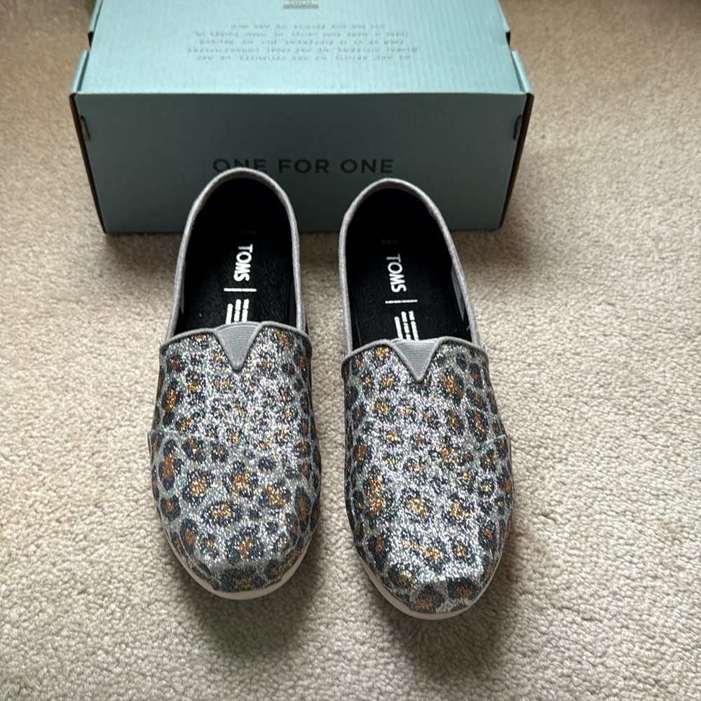 Tom’s women’s Classic Silver Cheetah Print Slip Ons. New. Never Worn. Size 6.5.